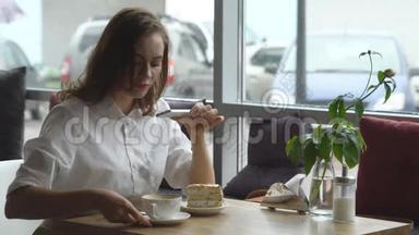 女孩在手机摄像头上为一个<strong>流行</strong>的社交<strong>网络</strong>拍照咖啡和蛋糕