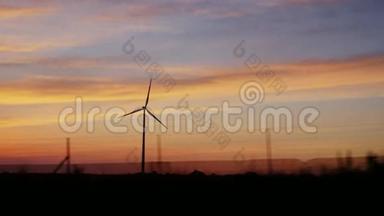 用风力发电机在乡村上空日落. 从一辆旅行车的窗户看风景