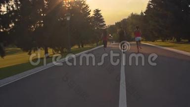 健身妇女在公园路上跑步。 日落时分，妇女在户外跑步