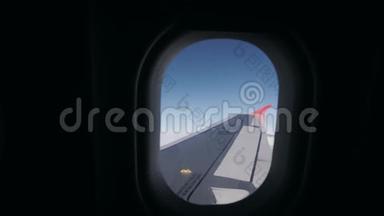 从窗外看飞机，从飞机的窗外看飞机的机翼、蓝天和云彩