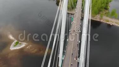 一个人走在一根绳子上，绳子在桥的支架之间在高空。