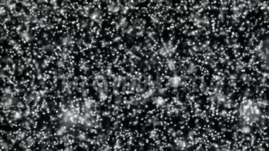 黑色背景下飘落的雪或白色抽象粒子的概念。