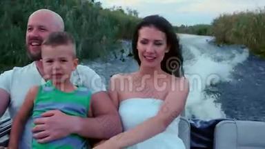 幸福的一家人很快就乘着快艇沿着河走了，幸福的母亲、父亲和儿子享受着假期，坐着船