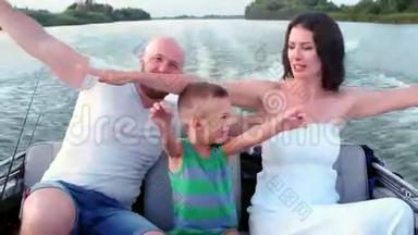 快乐的一家人乘着小船，父母带着一个孩子过着欢乐的夏日，乘着快艇快速地<strong>沿河</strong>而行
