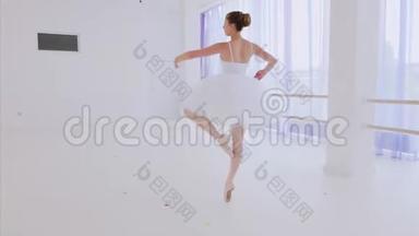 穿着白色芭蕾舞裙和尖头舞的芭蕾舞演员在芭蕾舞课上跳舞。