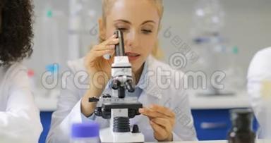 女科学家用显微镜研究混合种族研究小组在实验室的研究结果