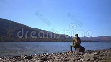阿尔泰。 两个<strong>视频</strong>合一.. <strong>露营</strong>妇女坐在山湖畔.. 穿着登山靴的女孩的脚