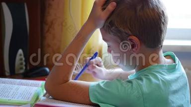 孩子在做作业，在桌上看书