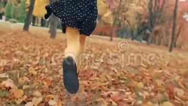 小可爱的小女孩，一头卷发，穿着圆点花纹的裙子，穿过公园里的秋巷