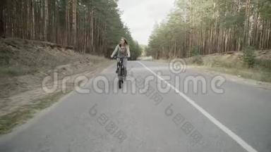 一个穿灰色<strong>运动服</strong>的金发女郎骑自行车。 一个穿灰色<strong>运动服</strong>的金发女郎骑自行车。