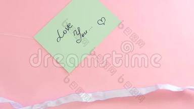 蝴蝶结系在粉红色背景上的一张纸上