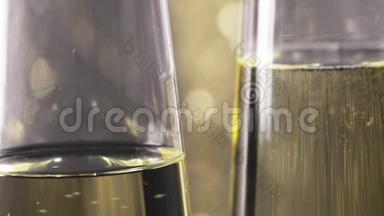 在<strong>金色</strong>bokeh背景下，用<strong>金色气</strong>泡填充香槟长笛的特写镜头，黄金豪华假日的概念