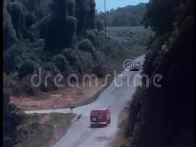 警车在乡间道路上追逐红色货车的高角度视角