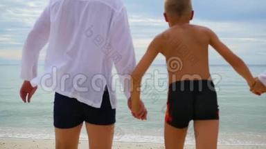 幸福的一家人牵着手沿着海岸奔跑。 在水里奔跑会产生飞溅
