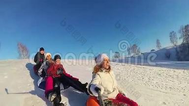 幸福的家庭乘坐和微笑的雪管在雪道上。慢动作。 <strong>冬天</strong>的雪景。 <strong>户外运动</strong>。 日落