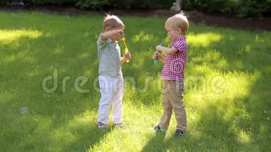 日落时分，两个有趣的小孩子正在公园里玩肥皂泡。