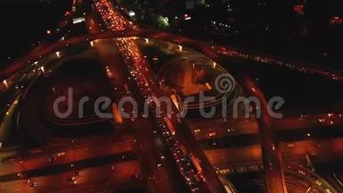 4K. 高速公路立交的鸟瞰图，夜间繁忙的城市交通在道路上<strong>超速</strong>行驶。 连接网络