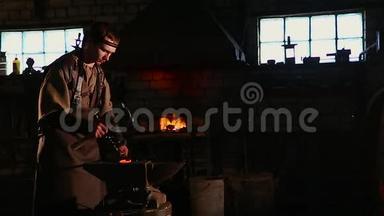 铁匠用火花焰火把铁砧手工锻造。
