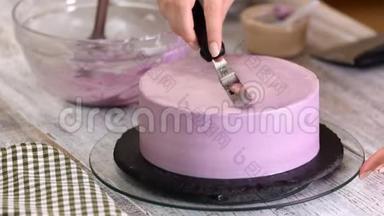 用紫色奶油盖装饰<strong>蛋糕</strong>的过程。 甜点师使用糕点抹<strong>刀</strong>将饼干奶油切等。