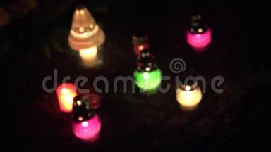在黑暗的坟地里集中更换五颜六色的蜡烛。 4K