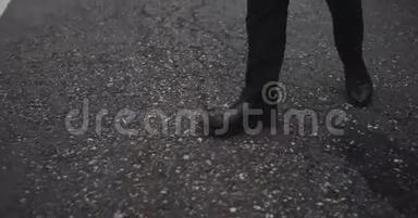 一个穿着黑鞋在路上行走的人，俯视，动作缓慢.. 4k