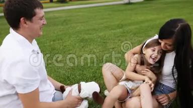 一家人在草坪上和女儿玩