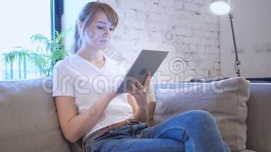 女人在平板电脑上<strong>上网</strong>，坐在沙发上