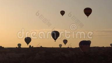 许多热气球飞过土耳其戈尔梅的山谷。 来自世界<strong>各地</strong>的游客来到