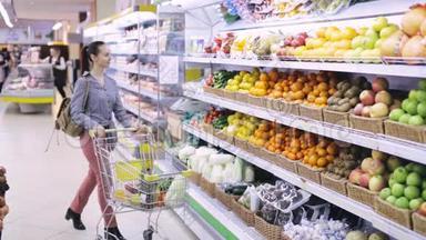 年轻女子在超市挑选水果