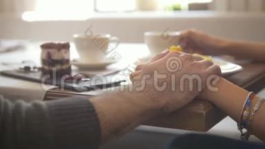 手牵着年轻夫妇在咖啡厅享受甜点