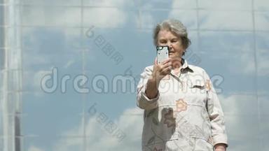 老年妇女使用银色智能手机拍照