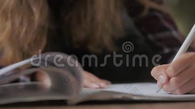女人的手拿着一本书，在阅读教育休闲读物时，手指在书页上移动