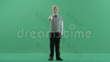 男生竖起大拇指，在绿色的屏幕背景上微笑
