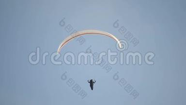 滑翔伞的飞行员在空中盘旋。 飞行员滑翔伞对抗蓝天