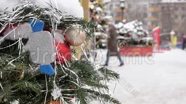 圣诞树上覆盖着雪，上面装饰着玩具。 在街上，有一场暴风雪。 在后台，出去
