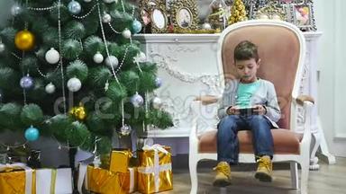 男孩在圣诞树附近玩手机、儿童和智能手机