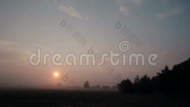 日出时的乡村景色伴随着薄雾慢慢地离开了草地。 太阳升起时会更亮。 时间推移