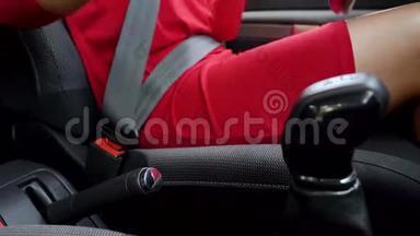 在驾驶前，身着红色礼服的女士在车<strong>内</strong>系紧<strong>安全带</strong>