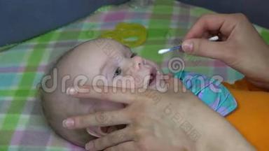 宝宝脸和女人手用棉棒清洁鼻子。 4K