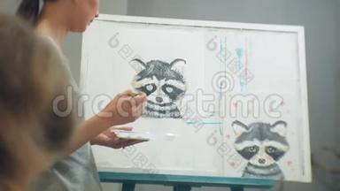一位年轻英俊的老师在黑板上画画，在<strong>美术课</strong>上教书