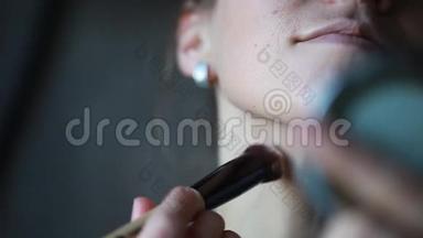 女人正在用刷子化妆