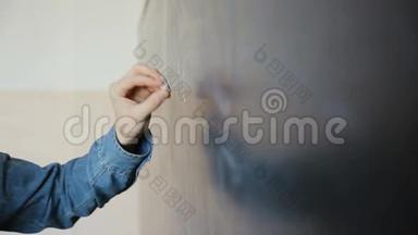 男科学家在黑板上书写<strong>高中</strong>数学和科学公式的手