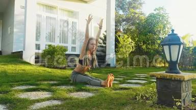 年轻女子正在她家后院做瑜伽练习。