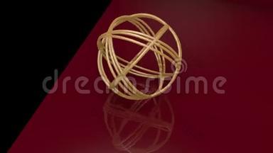 由金环组成的金球形结。 物体在黑色和暗红色背景上旋转。 几何镜像
