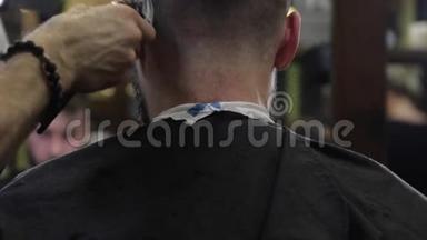 理发师用理发工具剪了客户黑发<strong>男子</strong>的<strong>头发</strong>。