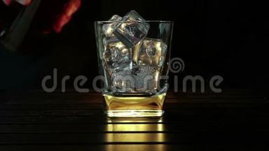 酒吧老板把威士忌倒在杯子里，木桌上放冰块，黑黑的背景，重点放在冰块上，威士忌放松时间
