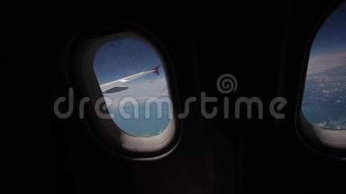 透过飞机的窗户观看蓝天和云彩，用飞机的翅膀关闭飞机的窗户