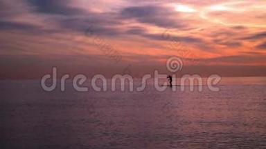海上日落。 日落时冲浪板上的人。 海上日落。 日落景观