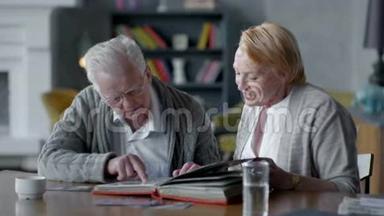 年长的幸福夫妇在一起，怀<strong>旧</strong>。 他们看着<strong>旧相册</strong>，微笑着