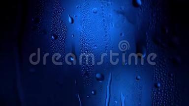 <strong>一滴水</strong>在<strong>一</strong>个玻璃特写宏观与闪闪发光的波克在蓝色模糊的背景。 抽象<strong>滴水</strong>。 雨滴